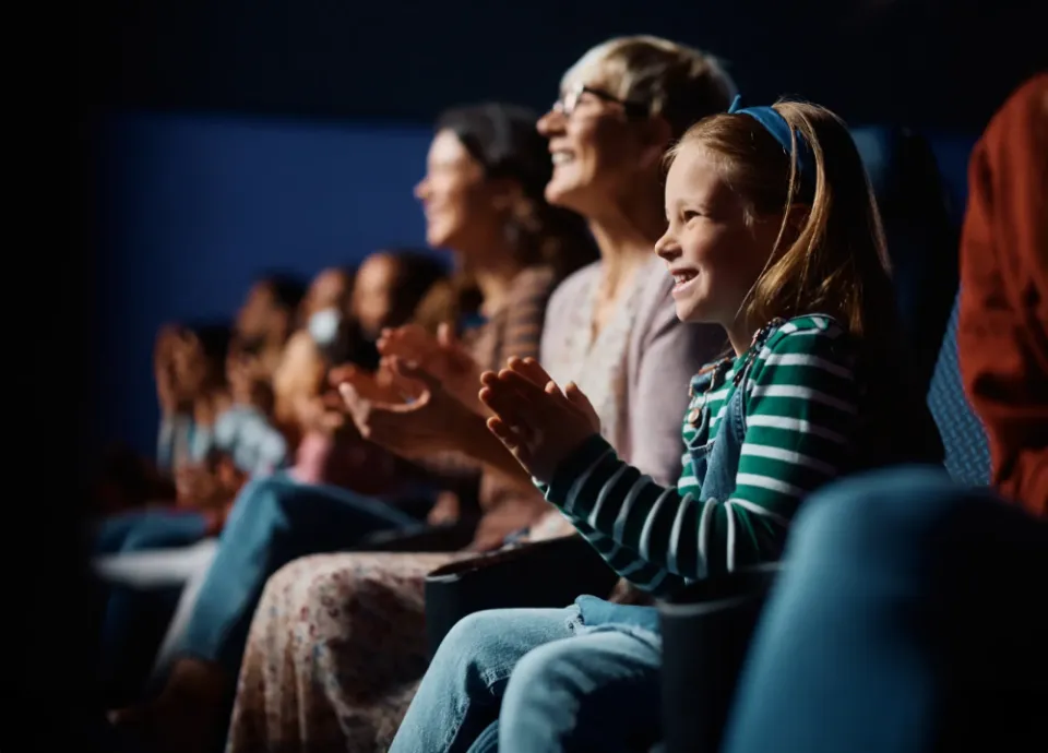 A crowd of kids and families enjoying the show together